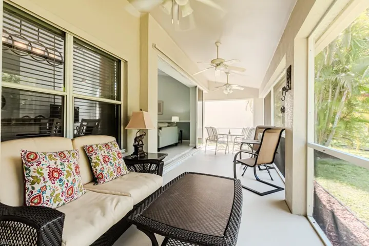 Screened lanai featuring ceiling fan and vaulted ceiling