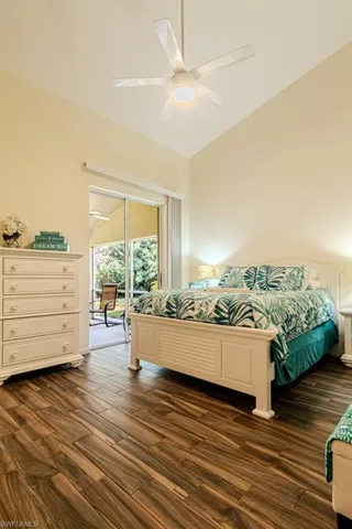 Bedroom featuring access to outside, ceiling fan, and dark wood-type flooring