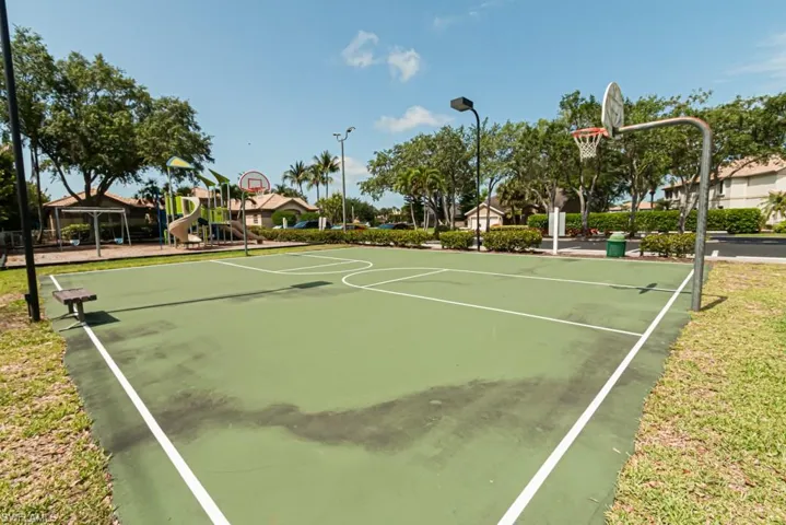 View of sport court featuring a playground
