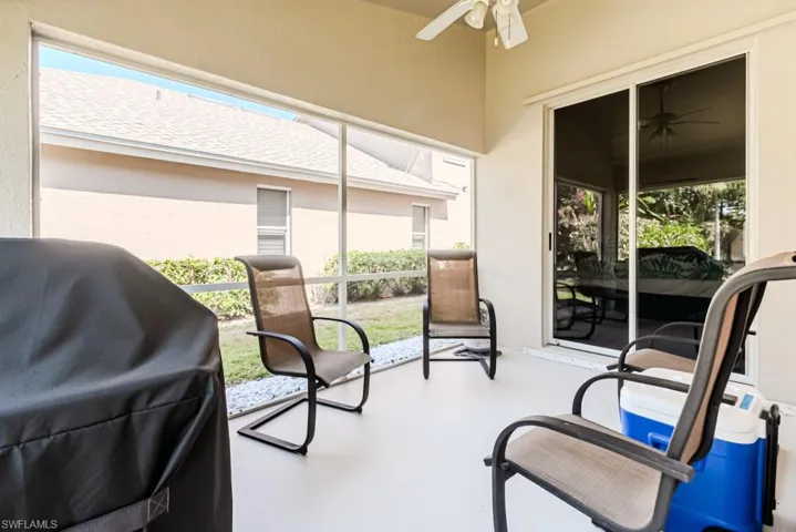 Screened lanai featuring plenty of natural light and ceiling fan