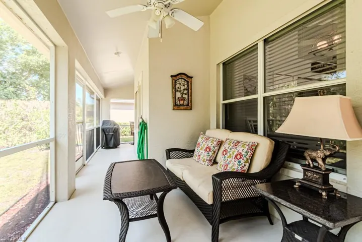 Screened lanai featuring ceiling fan and lofted ceiling