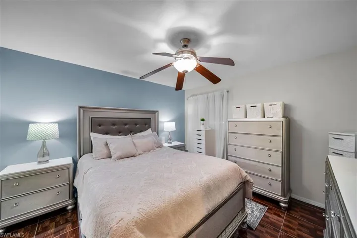 Bedroom featuring ceiling fan and dark hardwood / wood-style floors