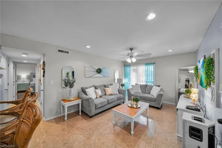 Tiled living room with heating unit and ceiling fan