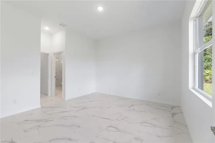 Unfurnished room featuring a wealth of natural light