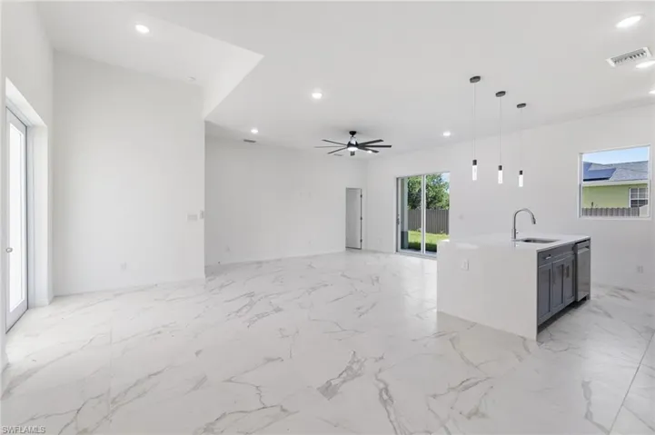 Living room featuring sink and ceiling fan
