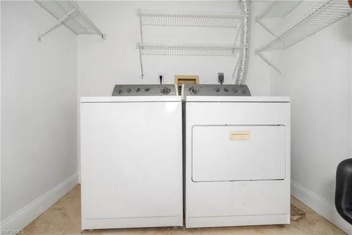 Laundry area featuring baseboards and washer and dryer
