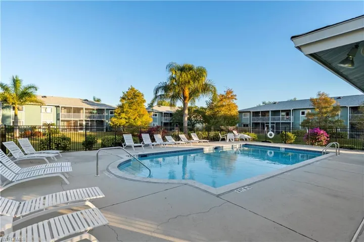 Community pool with a patio and a residential view