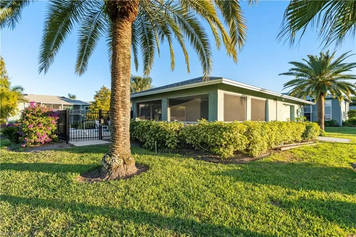View of home's exterior with stucco siding and a sunroom