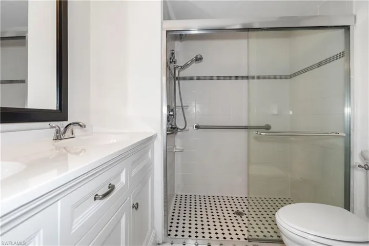 Bathroom with double vanity and a shower stall
