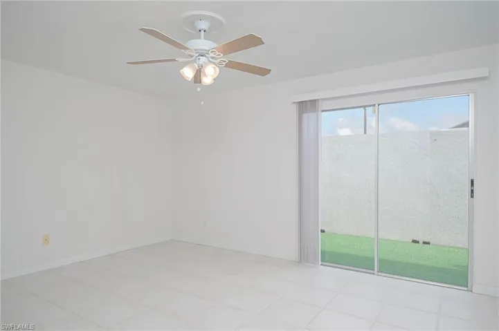 Unfurnished room with ceiling fan and light tile patterned flooring