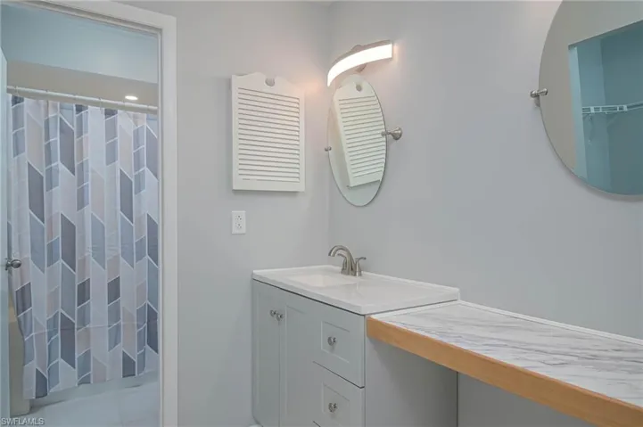 Bathroom with walk in shower and vanity