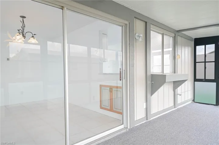 Unfurnished sunroom with an inviting chandelier