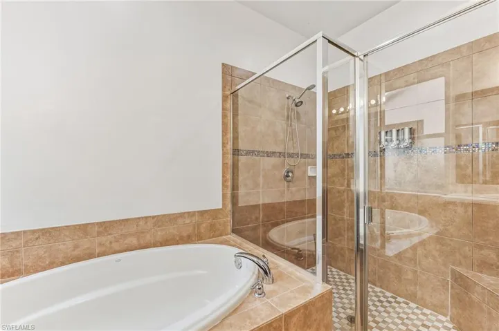 Full bathroom with a garden tub and a shower stall