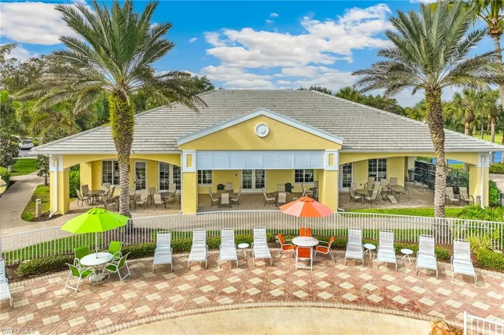 Rear view of house featuring a patio, stucco siding, outdoor dining space, and a tile roof