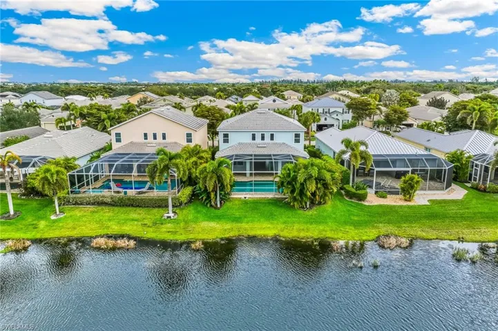 Aerial view of residential area featuring a nearby body of water
