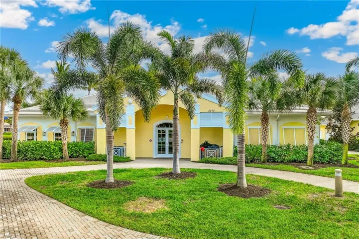View of property featuring curved driveway