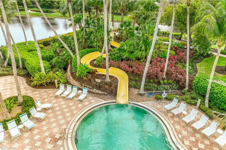 Community pool with a water view and a water slide