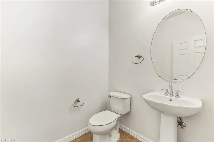 Bathroom featuring tile patterned flooring and baseboards