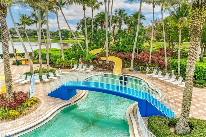 Community pool featuring a water view, a water play area, and a patio area