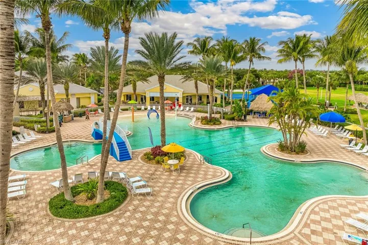 Community pool with a water play area and a patio