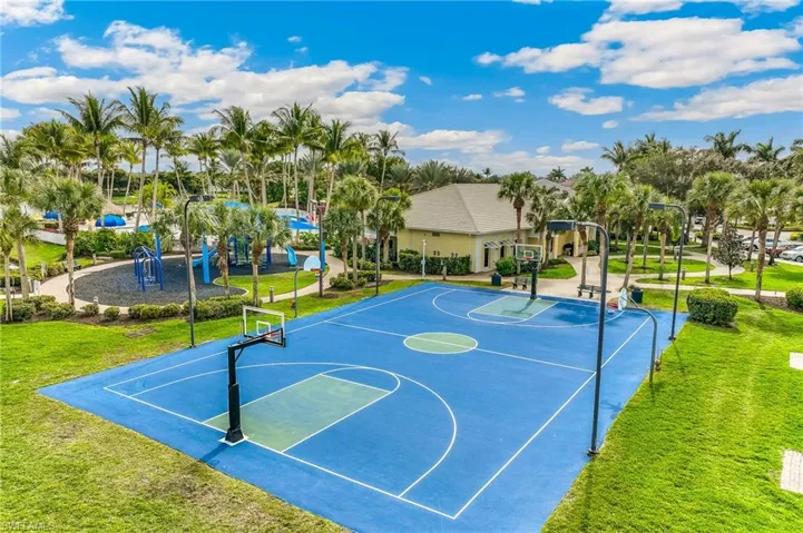 View of basketball court with a yard and community basketball court