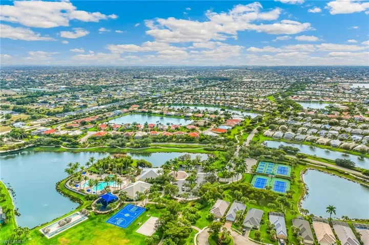 Aerial view of residential area featuring a nearby body of water