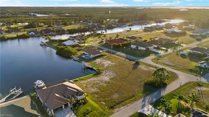Aerial perspective of suburban area featuring a nearby body of water