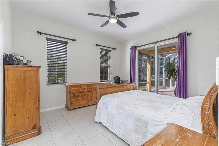 Bedroom featuring ceiling fan, access to exterior, and light tile patterned floors