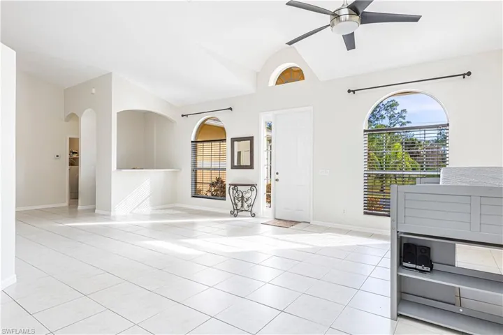 Unfurnished living room featuring ceiling fan and light tile patterned flooring