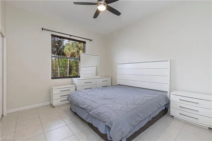 Tiled bedroom with ceiling fan
