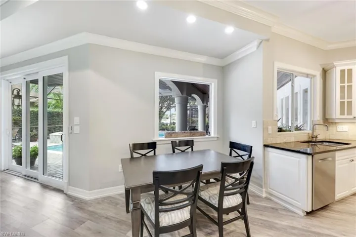 Breakfast area featuring light wood-style floors and crown molding