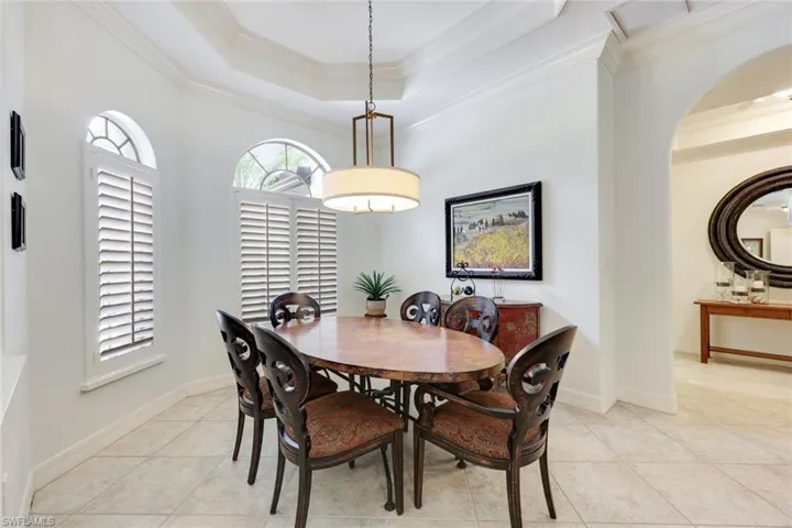 Dining room featuring decorative crown molding and a beautifully designed tray ceiling, creating a sophisticated and inviting space for memorable meals and gatherings.