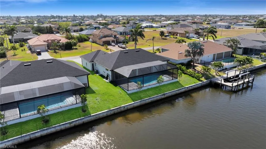 Drone / aerial view with a water view and a residential view