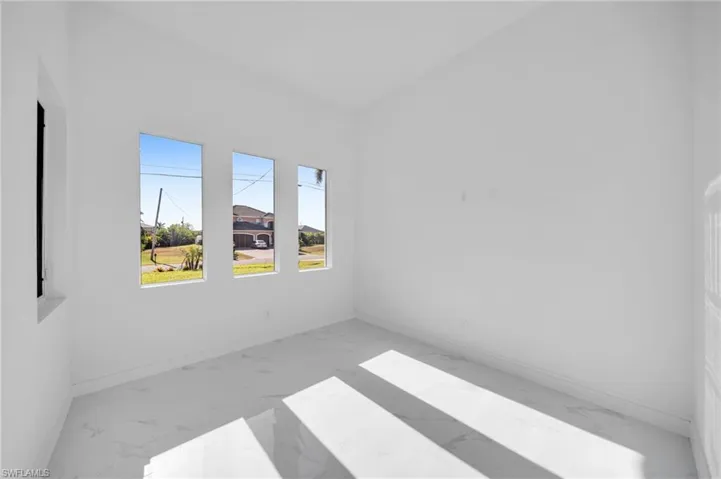 Spare room with baseboards and marble finish floor