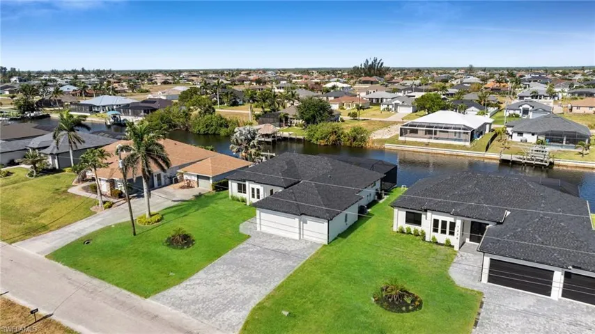 Aerial view featuring a residential view and a water view
