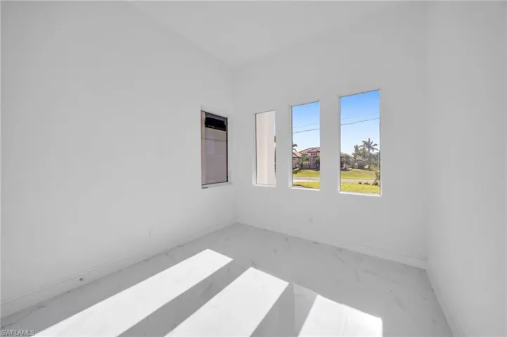 Empty room featuring baseboards and marble finish floor