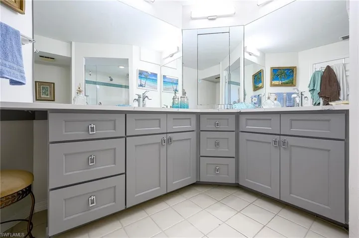new Bathroom with tile  flooring, vanity, and a shower with shower door