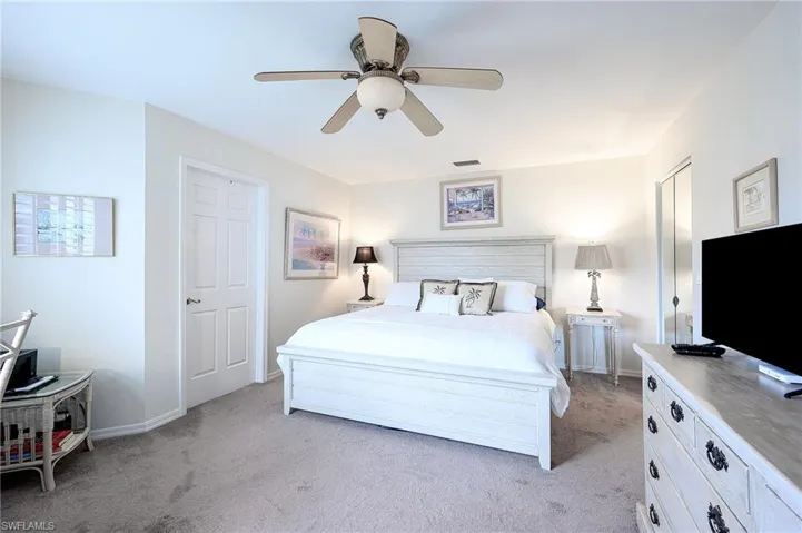 Bedroom featuring ceiling fan, desk