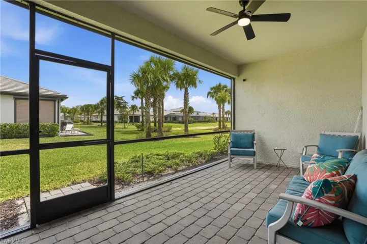 Sunroom / solarium with a ceiling fan and a residential view