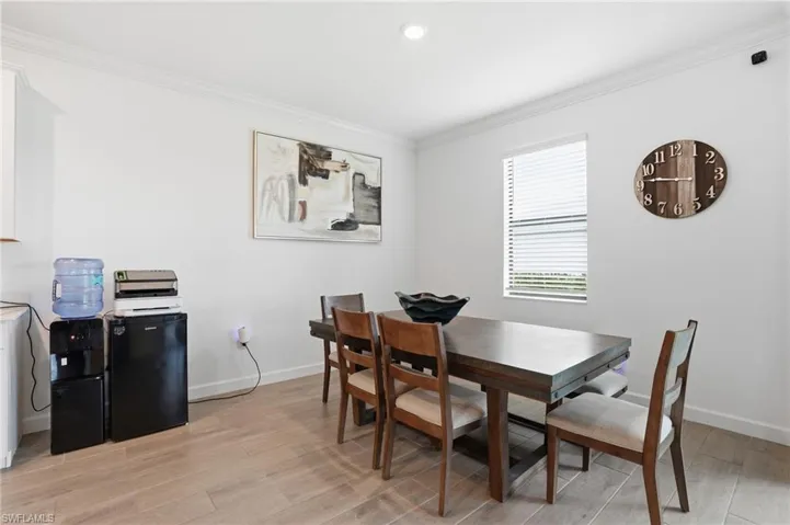 Dining room featuring crown molding, light wood finished floors, and recessed lighting