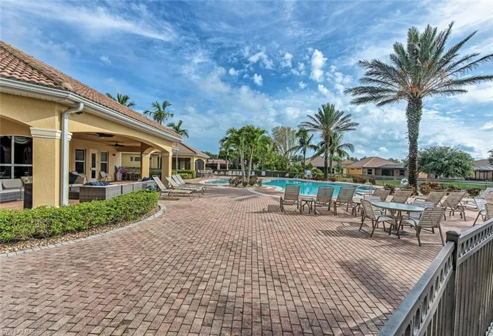 Community pool with a patio, a ceiling fan, and an outdoor living space