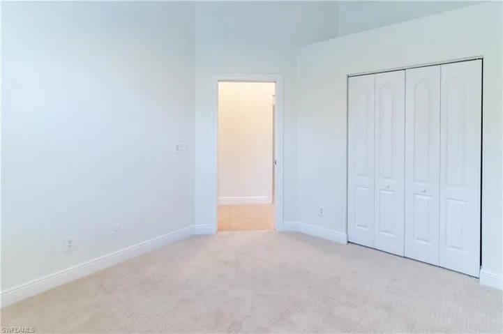 Unfurnished bedroom featuring carpet and a closet