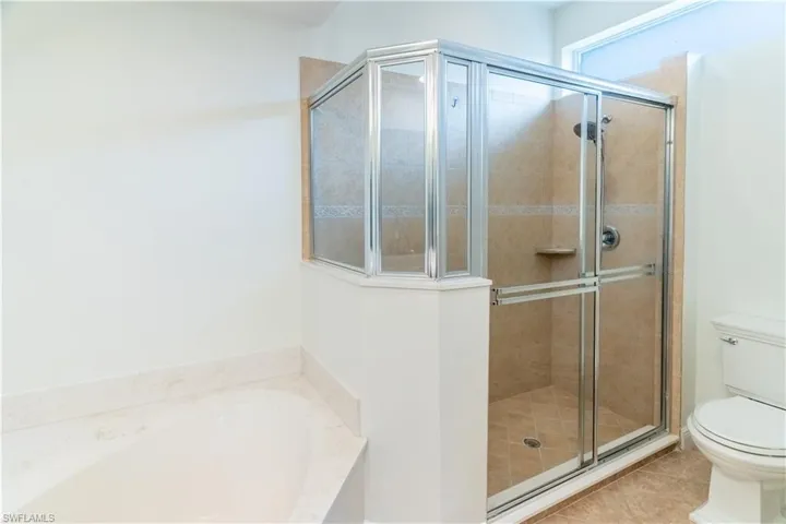 Full bath with a garden tub, a stall shower, and tile patterned floors