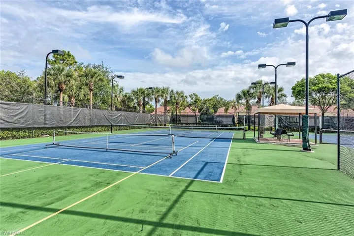 View of tennis court featuring a gazebo and community basketball court
