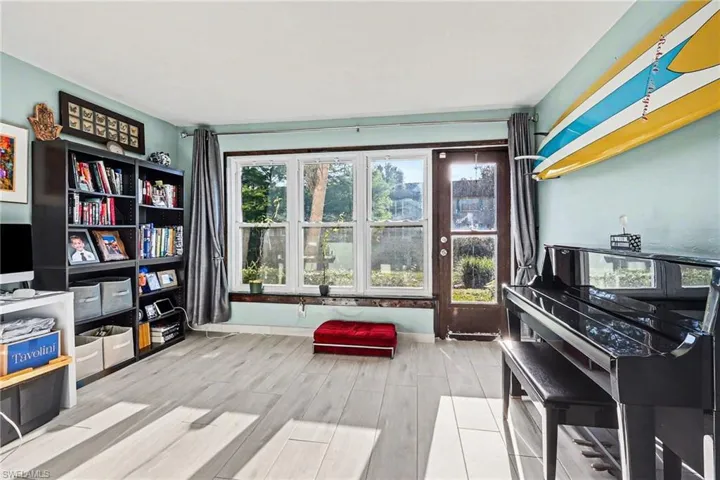 Sitting room with wood tiled floors and baseboards