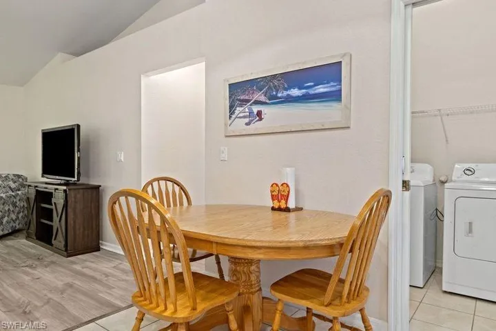 Dining area featuring light hardwood / wood-style flooring, lofted ceiling