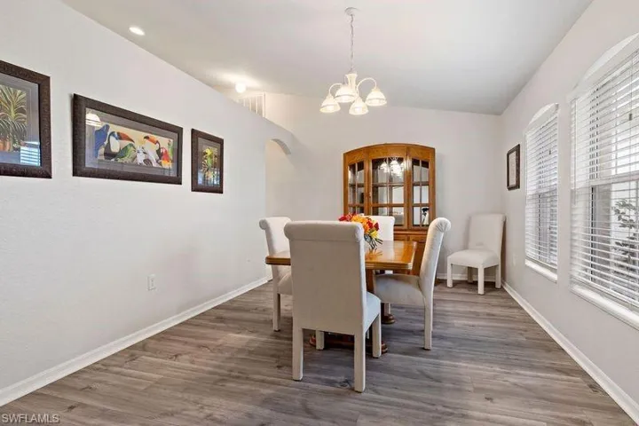 Dining room with new wood-type flooring. Large gathering space with easy access to the kitchen.
