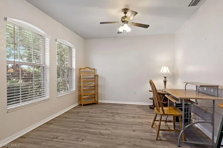 Home office featuring ceiling fan and wood-type flooring. This room has many options.