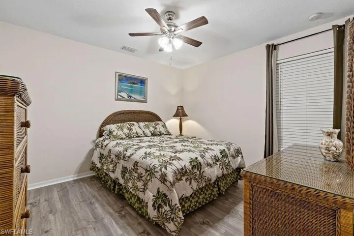Bedroom featuring ceiling fan and hardwood / wood-style flooring