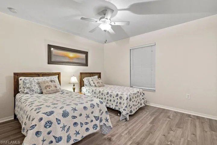 Bedroom featuring hardwood / wood-style flooring and ceiling fan